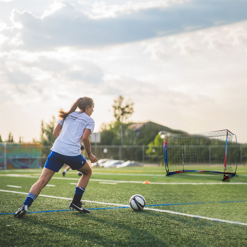 Load image into Gallery viewer, female player playing soccer with 8' x 5' Portable Soccer Goal Net